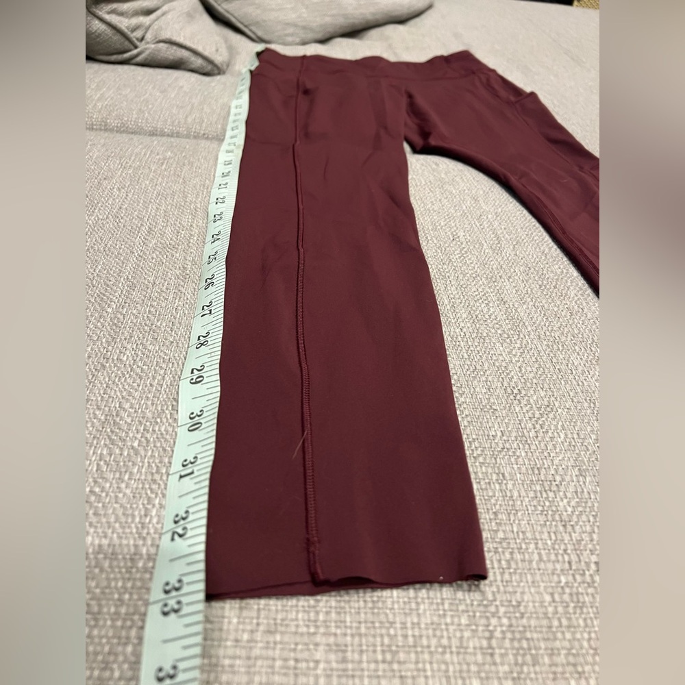 Maroon Lululemon 7/8 legging with side pockets and adjustable waist.